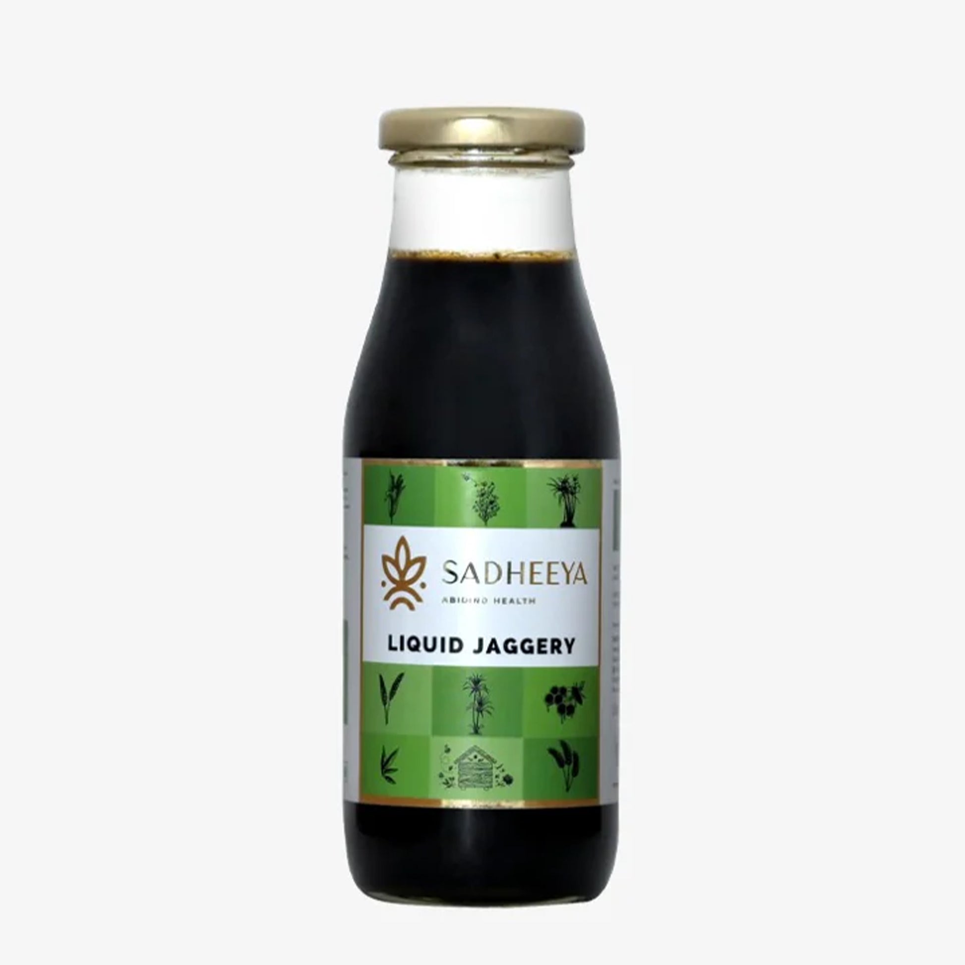 Sadheeya liquid jaggery in a glass bottle with a gold cap and green label, isolated on a white background.